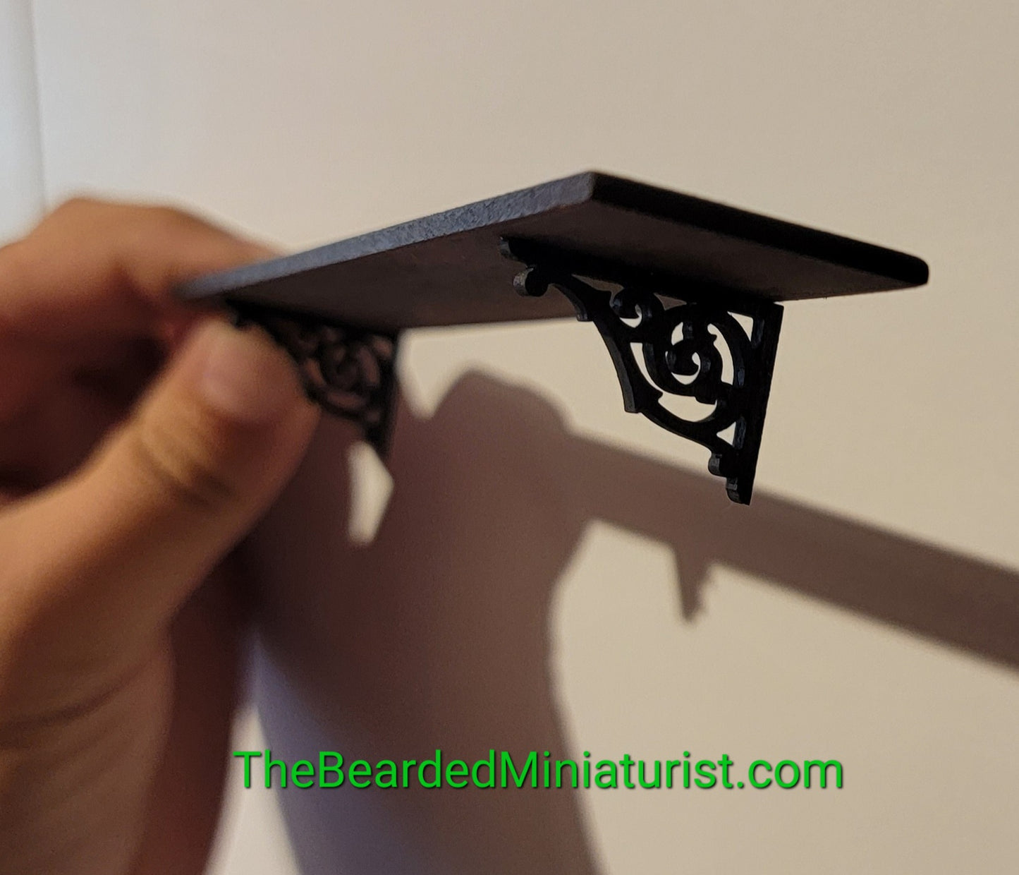 Wooden wall shelf with brackets.